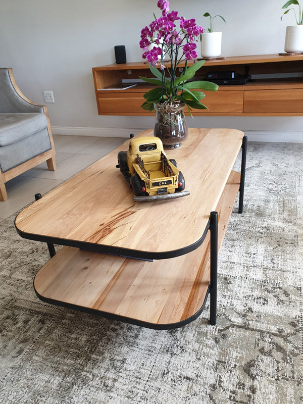 A handmade solid wood coffee table with a unique and modern design.