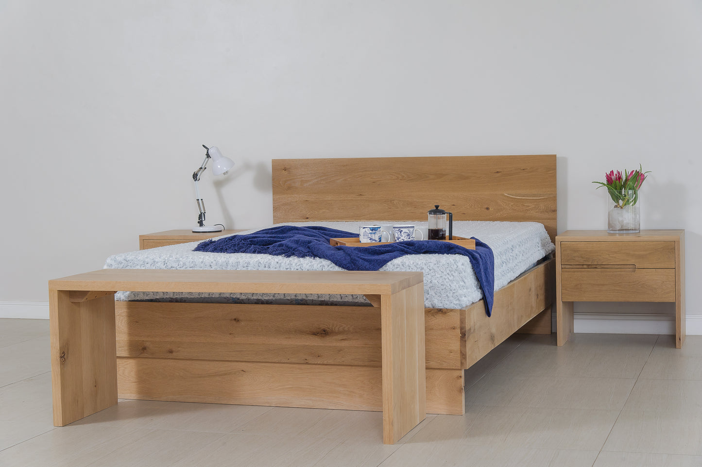 A Nina custom-made bed from Naka Furniture. The bed is made from high-quality solid wood and is available in a variety of sizes and finishes. It can also be customized to your specific needs and preferences.
